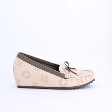 Beige ANON Moccasins Wedge with subtle patterns, wedge heel, and rubber outsole for comfort and grip, made from faux leather.